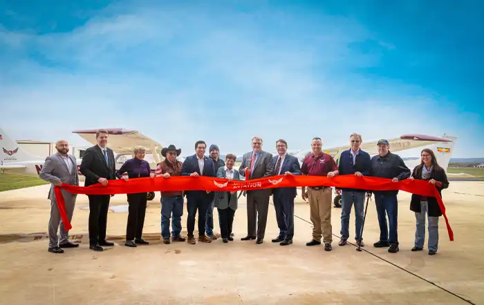 Community and Schreiner University leaders gathered at Kerrville Airport on November 10 for the official ribbon cutting for the new Aviation Program. Pictured left to right: Steve Kugler, Travis Frampton, Mary Rohrer, Don Harris, Roman Garcia, Dalton Rice, Judy Eichner, Carl Davis, Charlie McCormick, John Winslow, Harry Anthony, Dick Hatch, Katie Milton Jordan